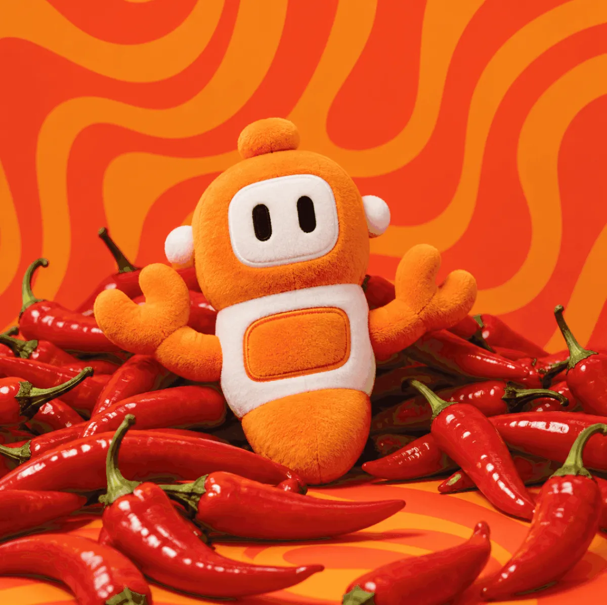 The chili agent plushie from the Chili Piper store, sitting on red chilies